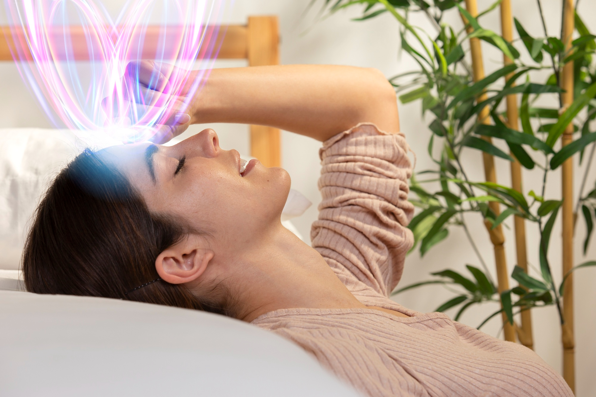 Smiling woman receiving Exomind Therapy treatment in a wellness clinic